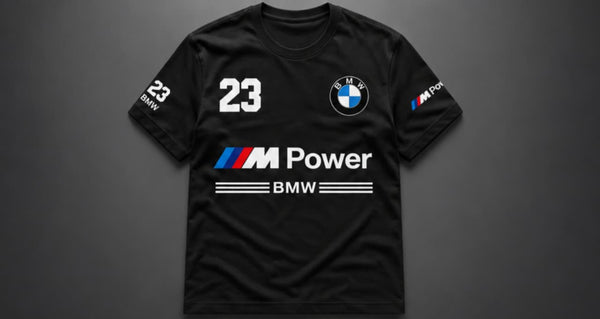 A black short-sleeve BMW M Power t-shirt with the number 23 on the chest, displayed against a dark gray background.